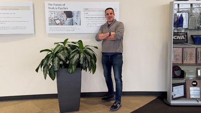 Nick Ruggeri, Senior District Sales Manager, Merchant Services at Paychex, stands in the company office.